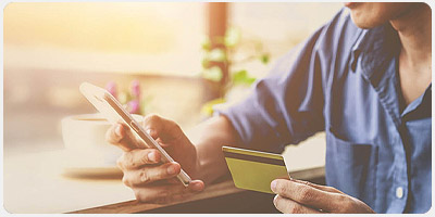 Man holding credit card and phone