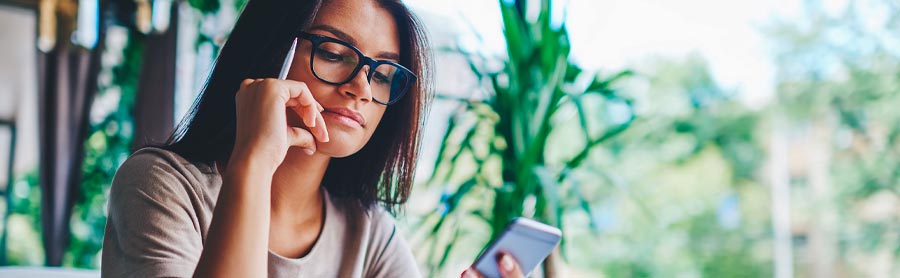 Woman looking at her Norton on her phone