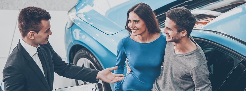 Couple meeting with an auto dealer