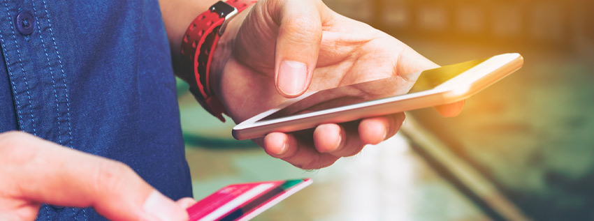 Holding a credit card and cell phone