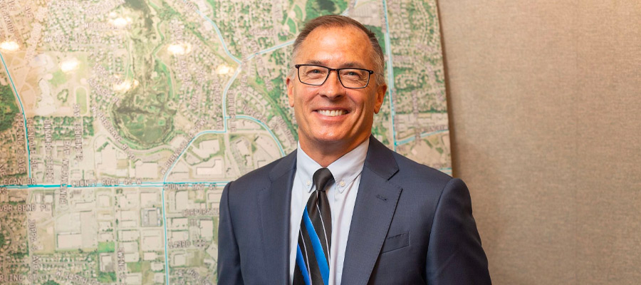 Business man standing in front of plans