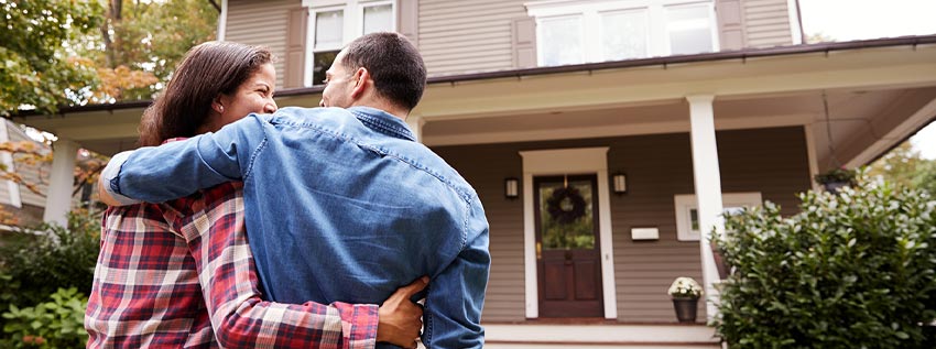 Young couple walking into their new home