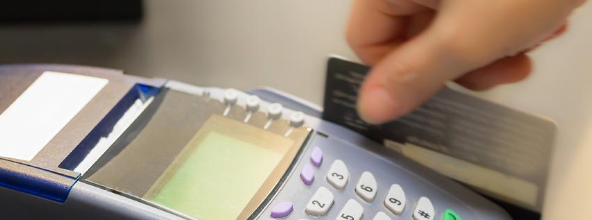Person swiping their debit card