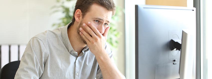 Man sitting at his desktop computer