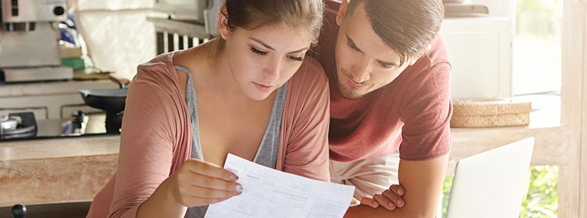 Couple sitting in from of finances and planning the future