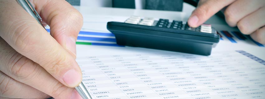 Man holding a pen and calculator