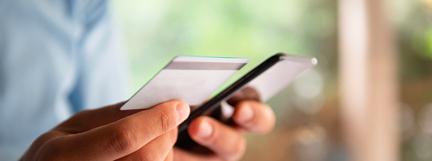 Man holding credit card and phone