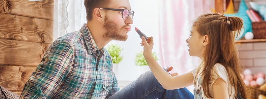 Father and daughter playing dress up