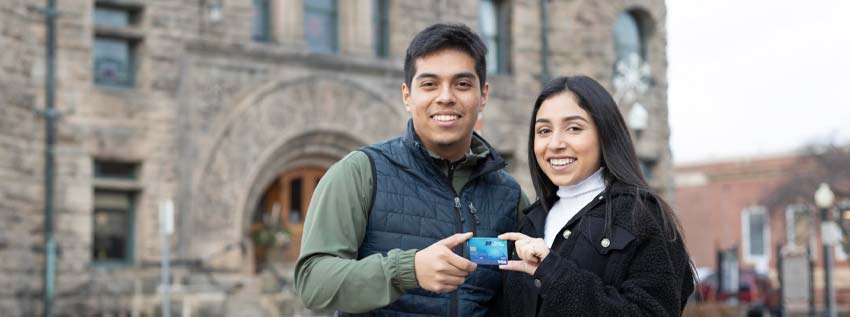 Young couple holding debit card