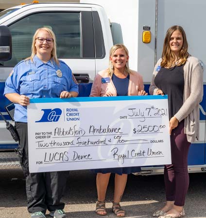 Photo of Members holding a big check