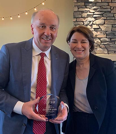 Photo of Jerry and Amy Klobuchar hilding his award