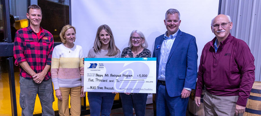 Group of RCU team members holding a big check