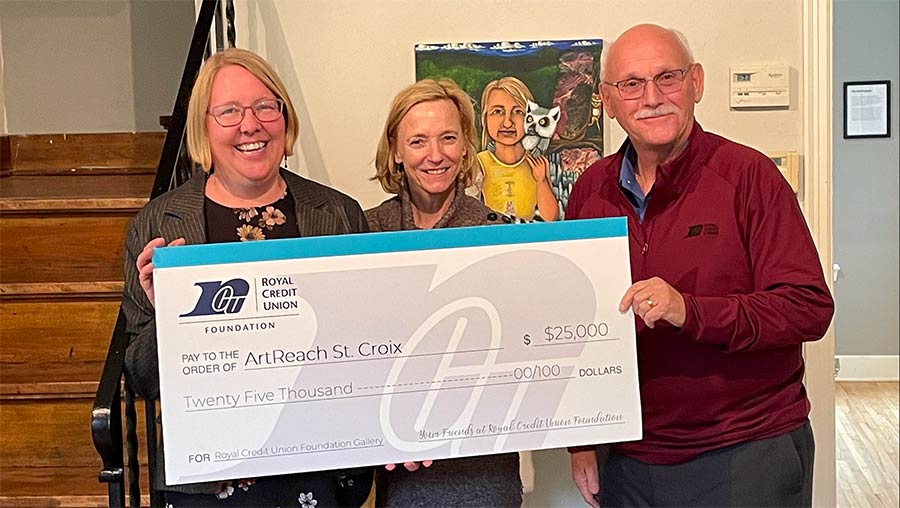 Team of folks standing with a big check