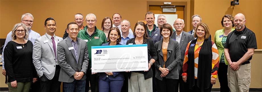 Group of people from RCU and CVTC holding a big check