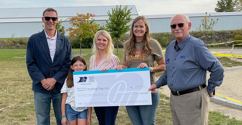 Foundation members and Fairyland members holding a large check