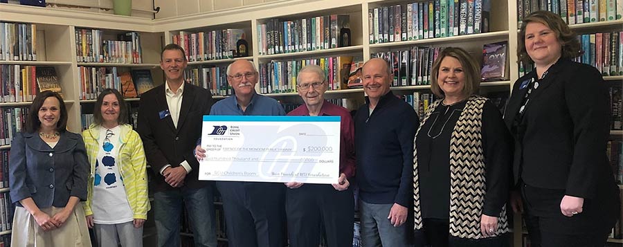 RCU and Mondovi Library folks holding a big check