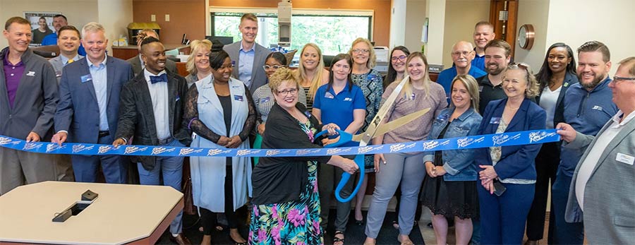 Ribbon cutting with staff and Leadership