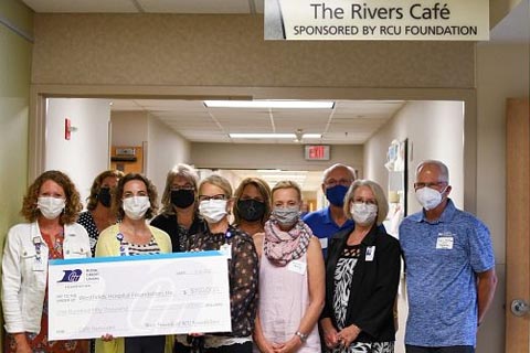 Photo of group of people holding a big check