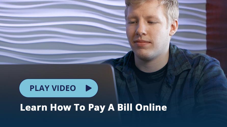 Young man paying a bill on his laptop