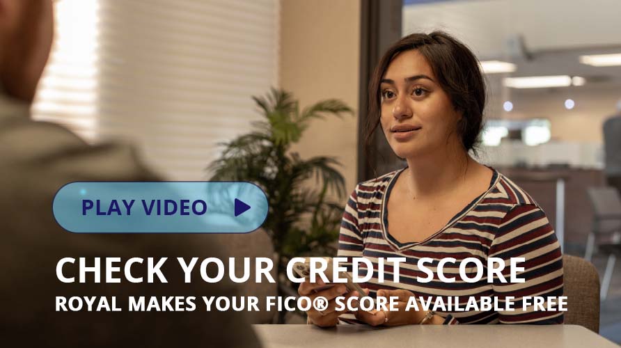 woman sitting at desk holding phone