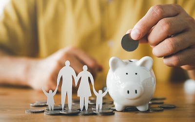 Piggy bank and paper cutouts of a family