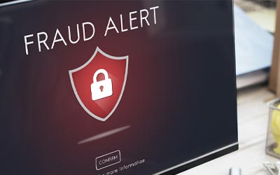 Man looking at his computer with a scam message