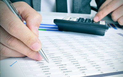 Person with a pen and calculator