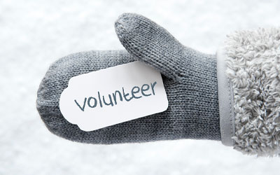 Person holding a volunteer sign