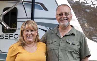 Couple in front of their RV