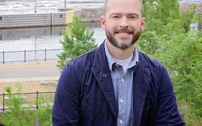 Man standing in front of river