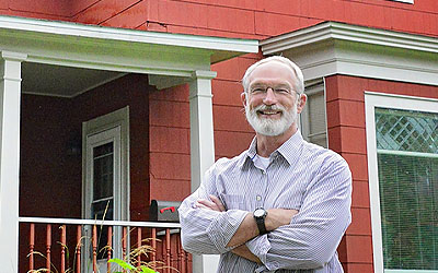 Man standing in front of his investment property