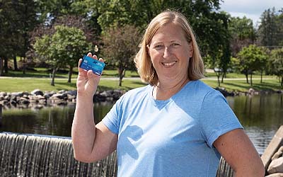 Happy woman holding RCU debit card