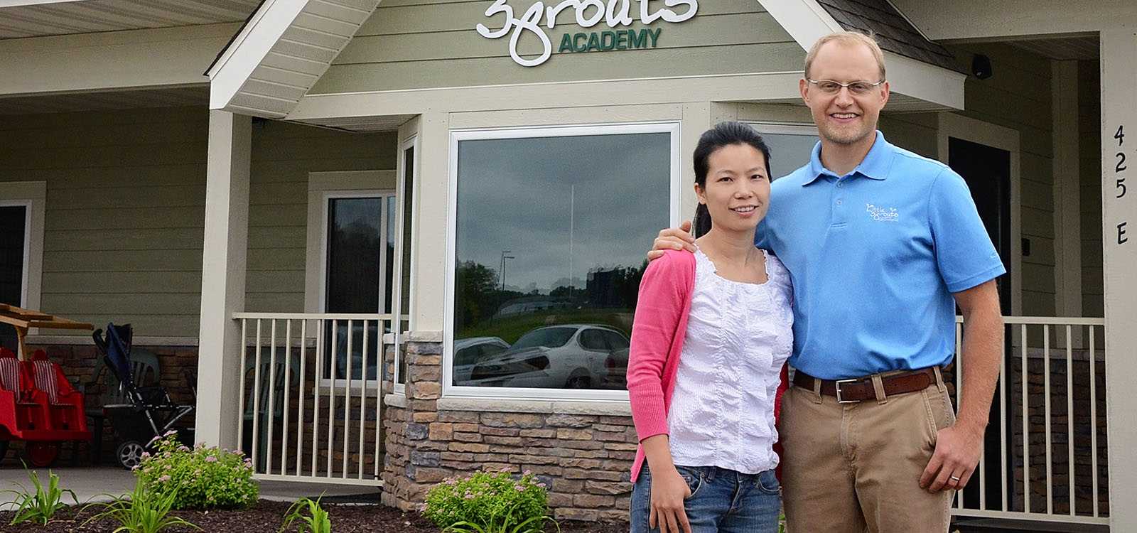 man and woman standing outside small business