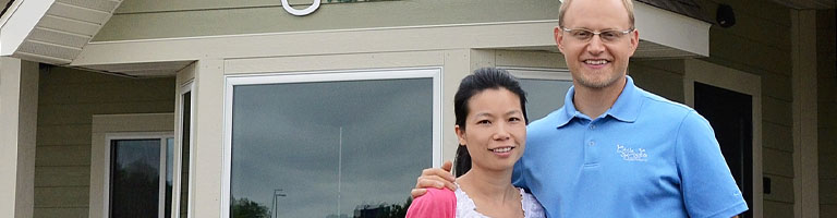 man and woman standing outside small business