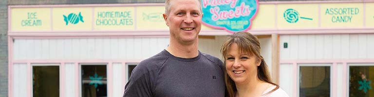 Couple standing in front of their business