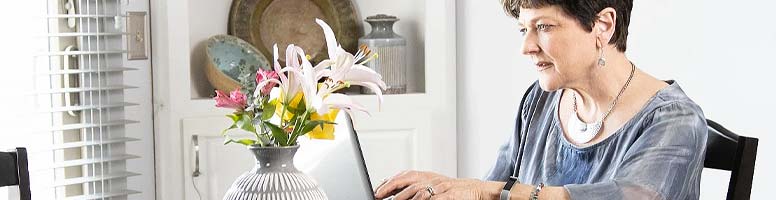Royal business owner looking at laptop