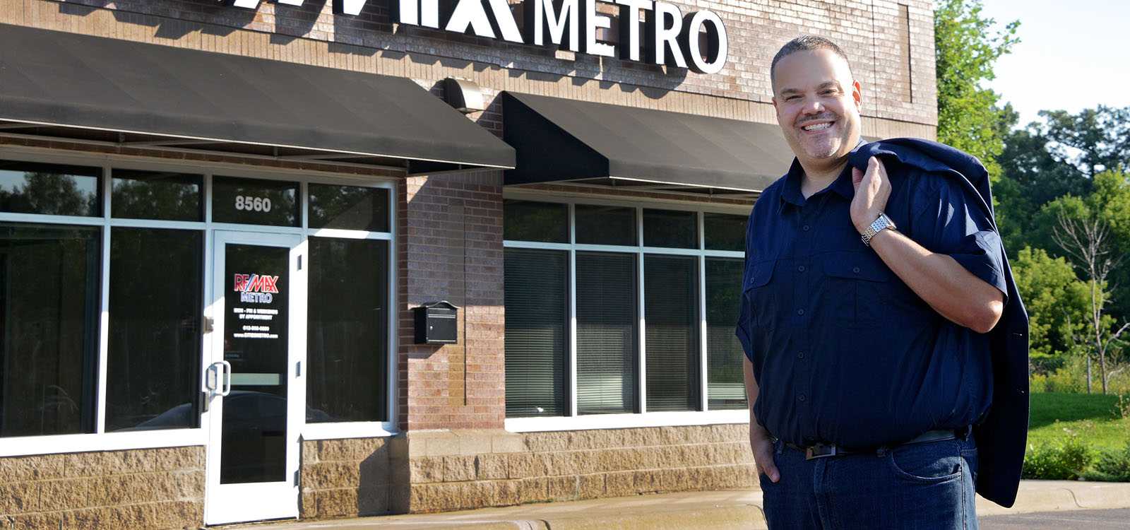 man outside real estate office