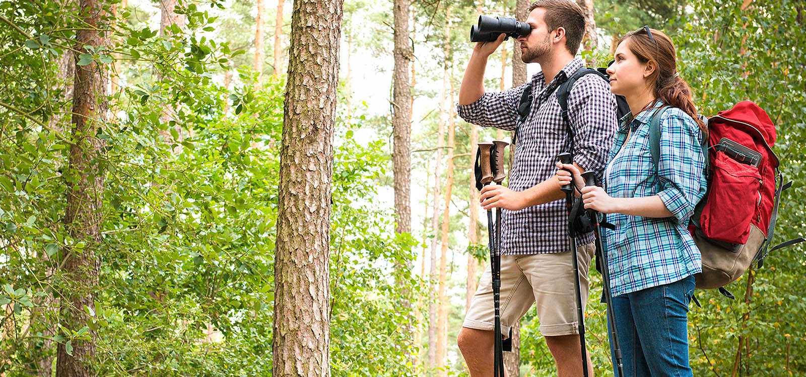 man and woman hiking in the woods