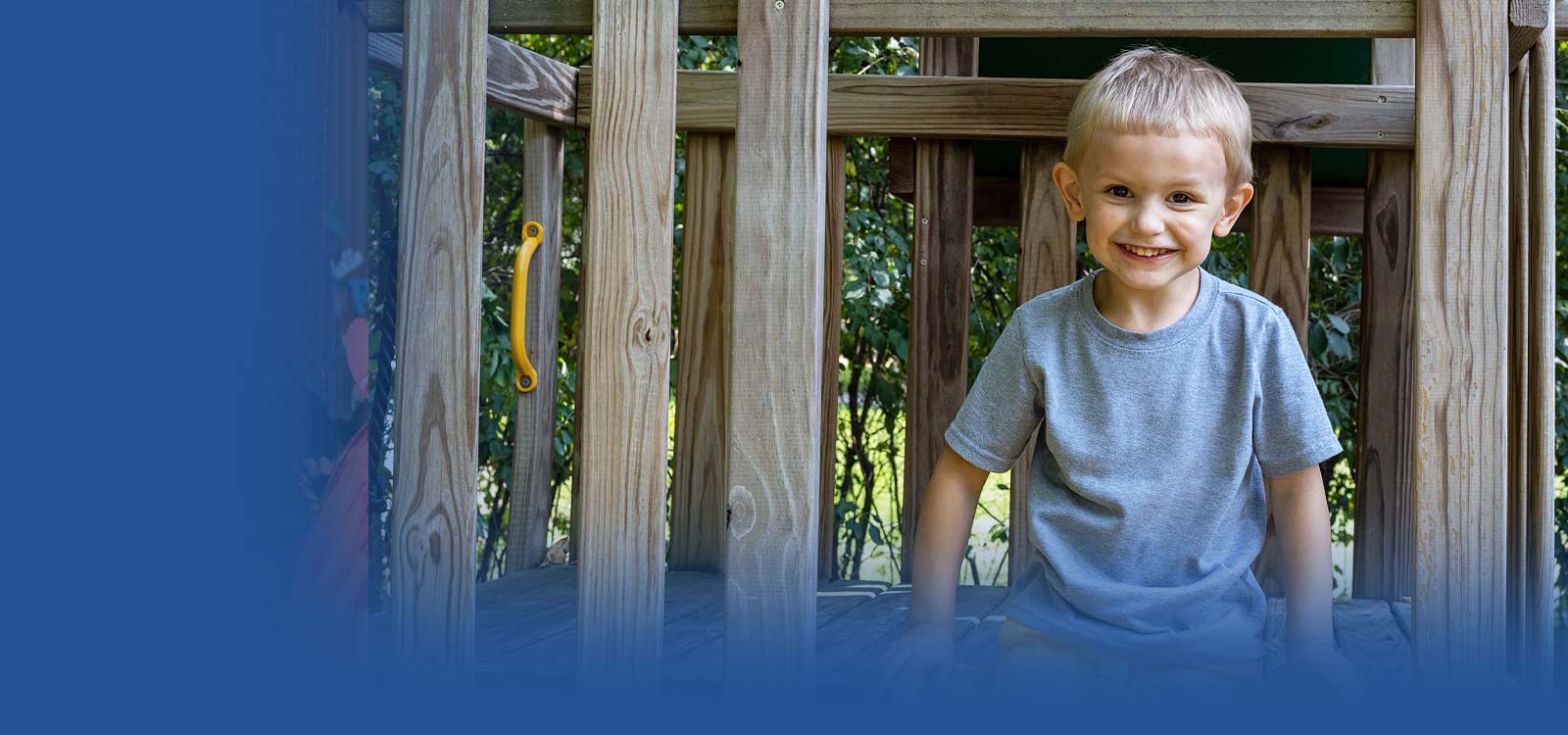 Child on a play set smiling