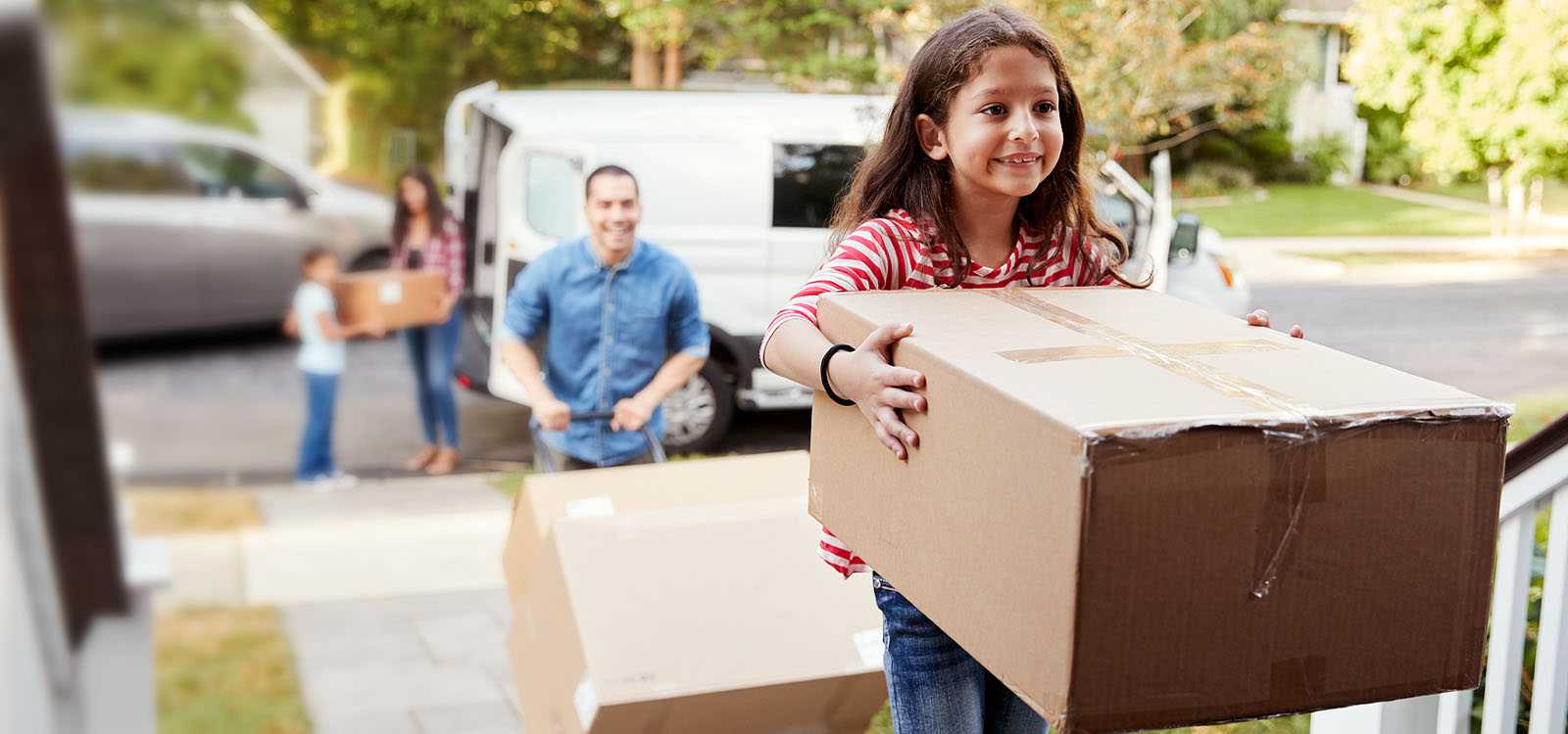 family moving boxes into new home