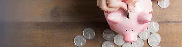 Childs hand and piggy bank