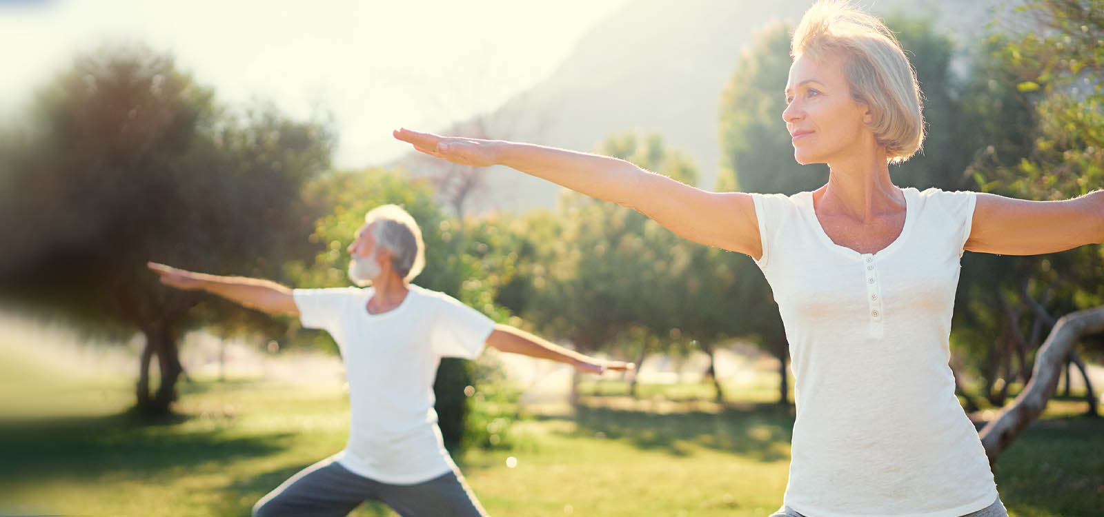man and woman doing yoga