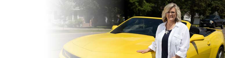 Woman standing in front of new car