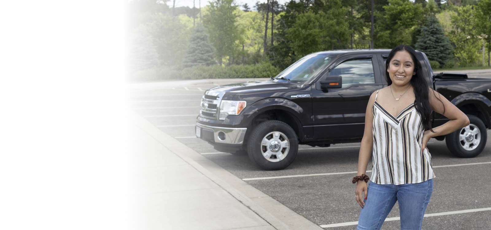 Woman standing in front of new car
