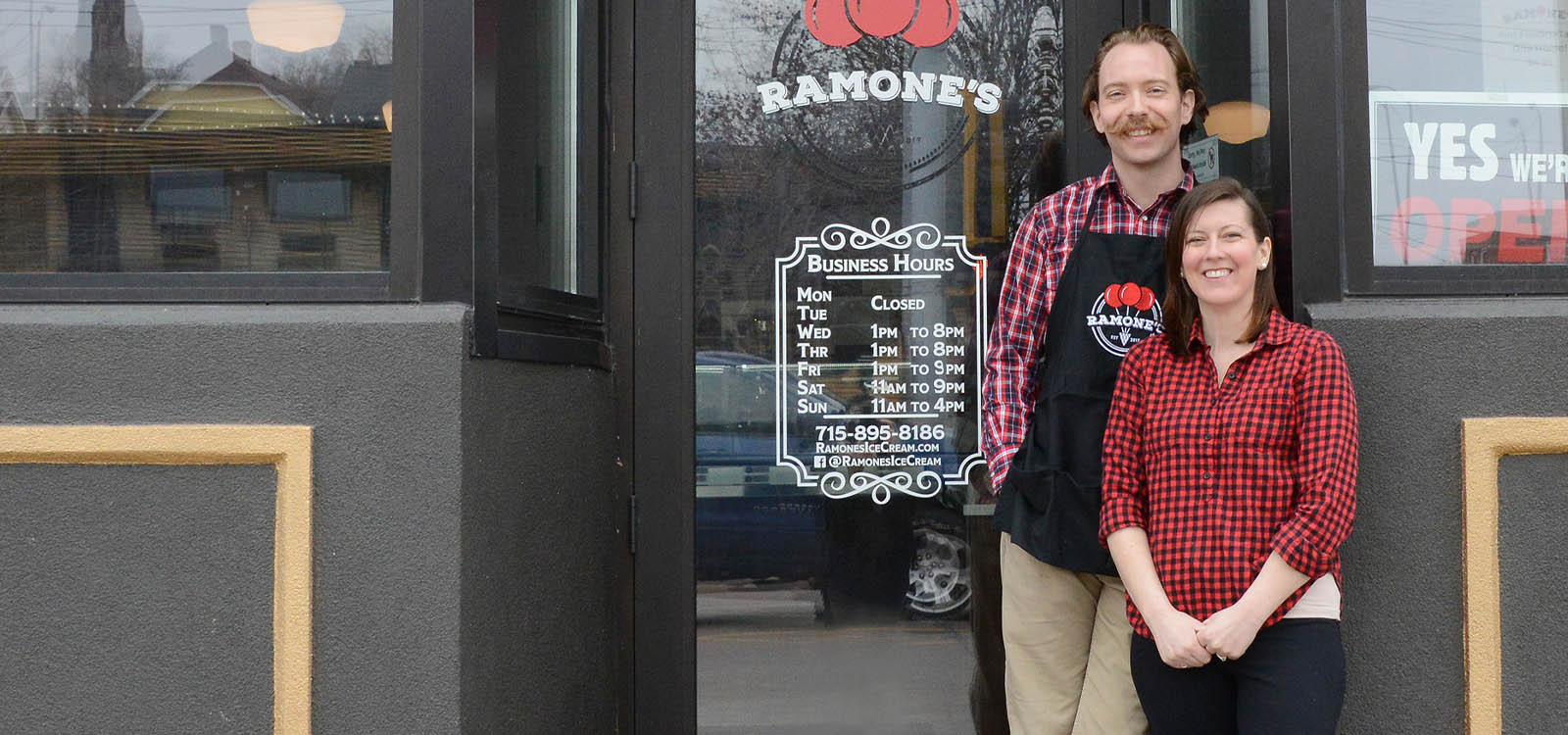 Local Business Owners In Front of Their Shop