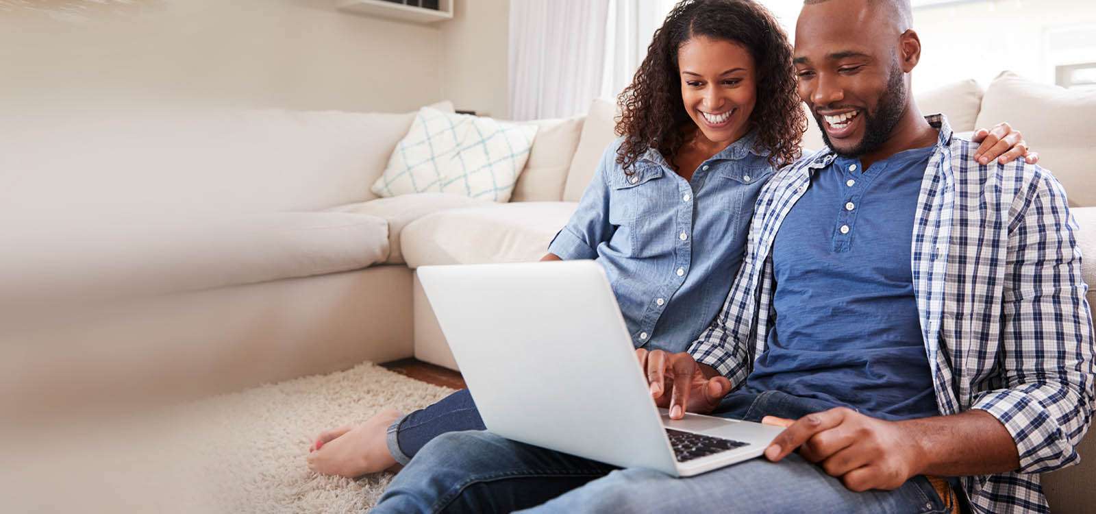 man and woman looking at computer