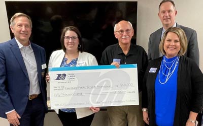 Photo of RCU team members holding a large check