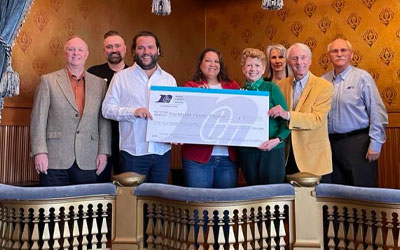 Group of RCU leaders holding a big check