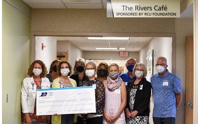 Group of RCU Members holding a big check