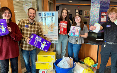 Group of Royal team members holding diapers